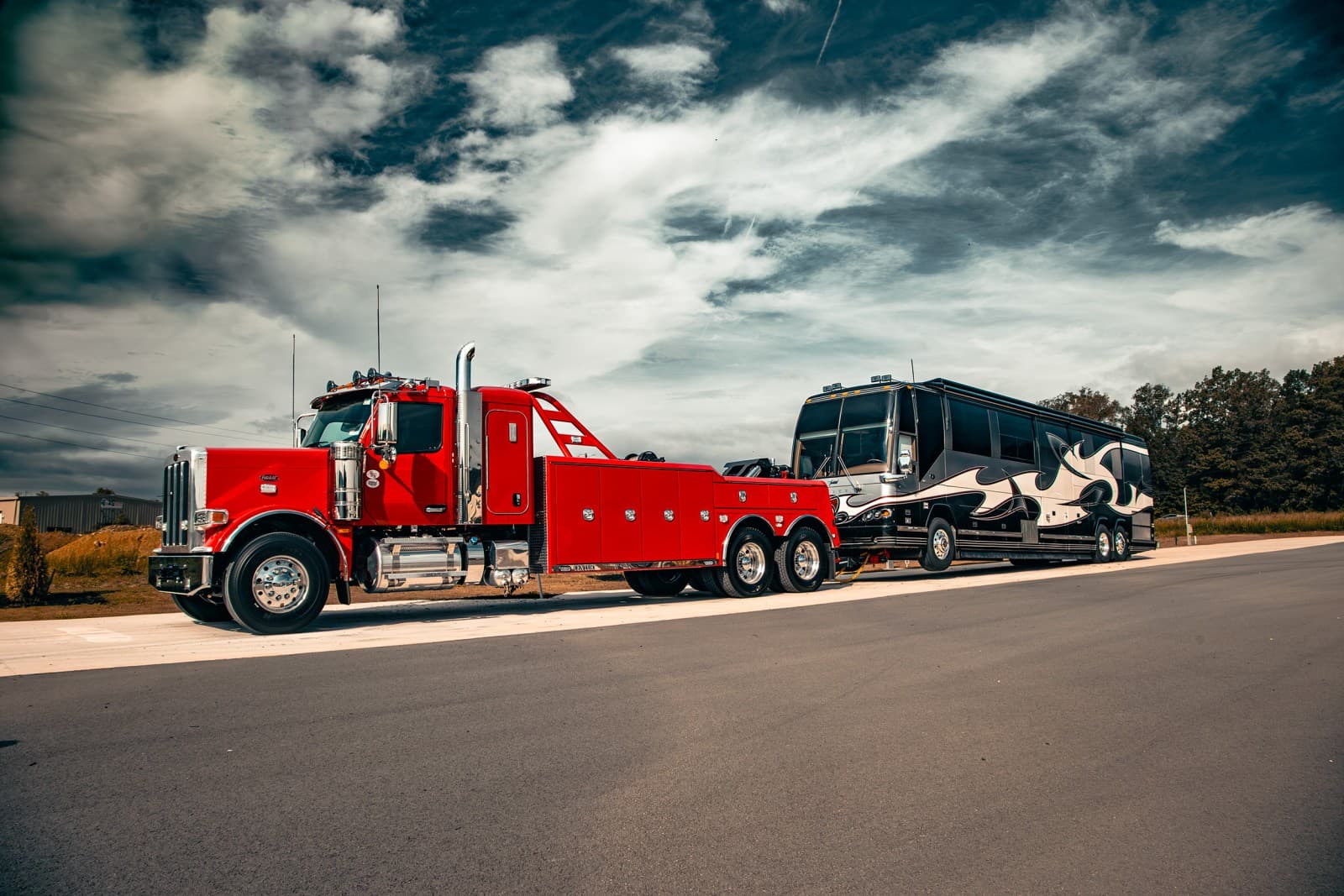 Miller Industries Century 5230 heavy-duty wrecker towing a motorcoach