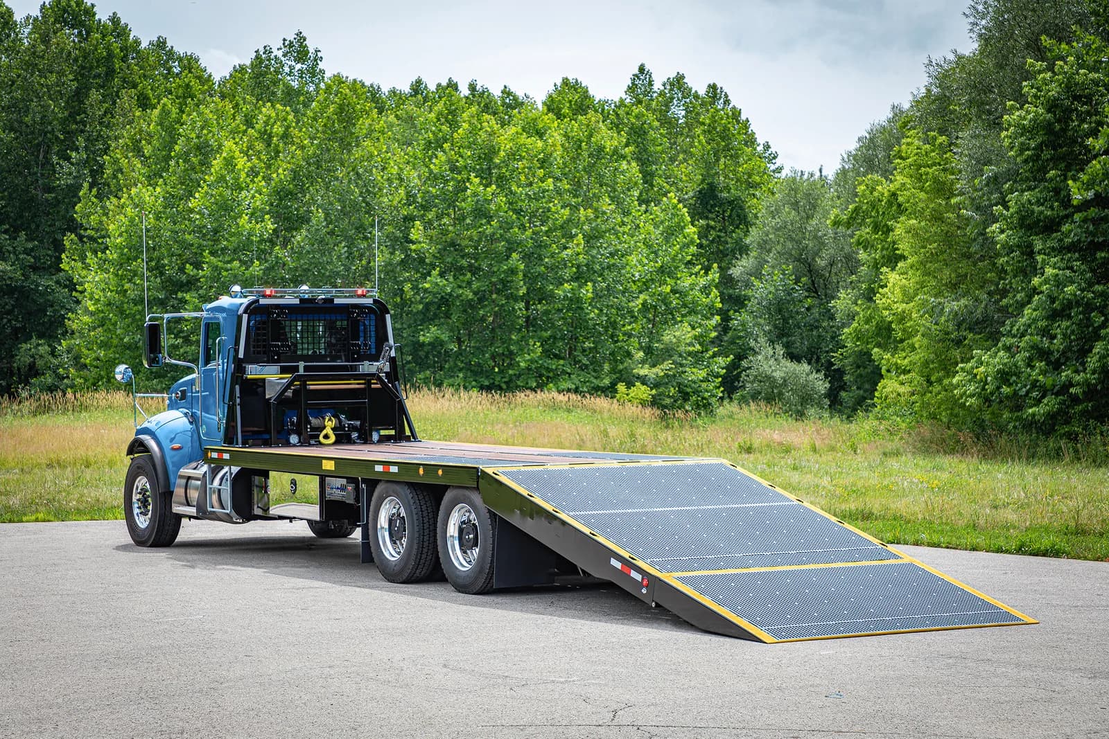 Miller Industries blue Titan folding ramp flatbed for special transport